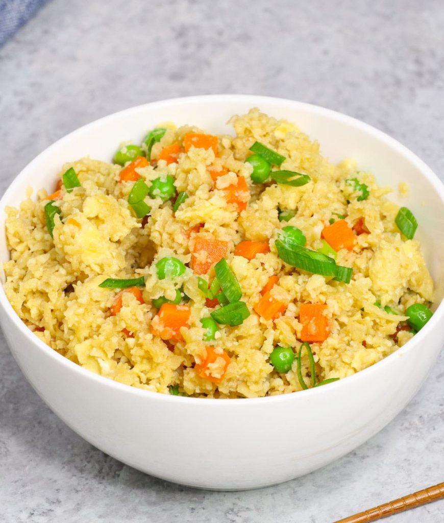 Microwave cauliflower rice served in a white bowl.