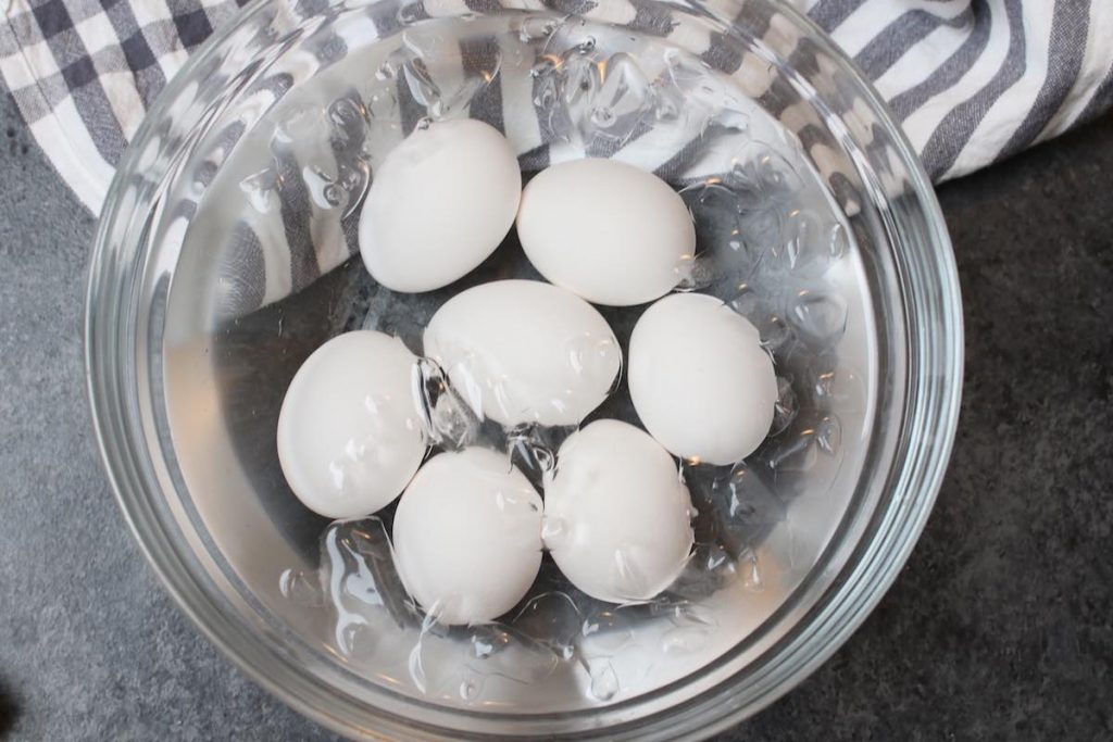 Soaking eggs in an ice water bath.