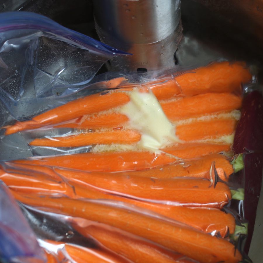 Cooking carrots in a sous vide water bath.