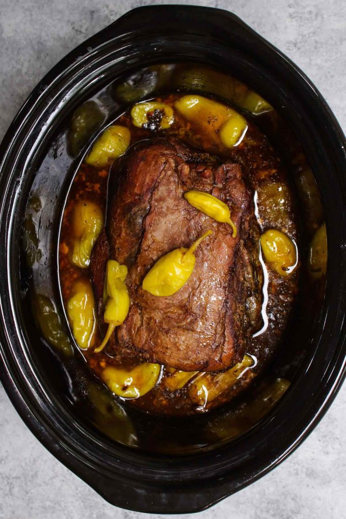 Freshly cooked Mississippi roast in a crockpot.