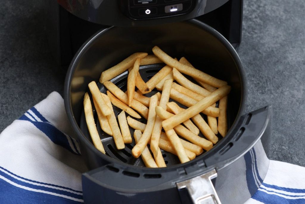 Frozen french fries cooked in an air fryer after 6 minutes.