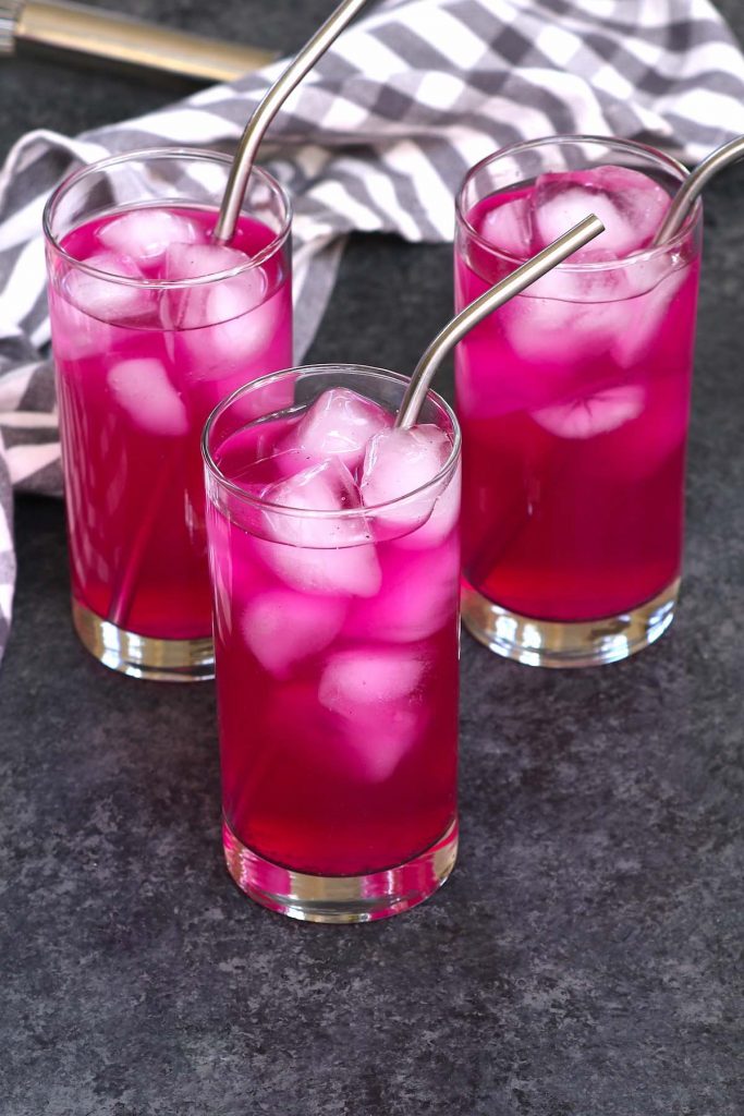 3 high-ball glasses of mango dragonfruit refresher on the counter, to be served.