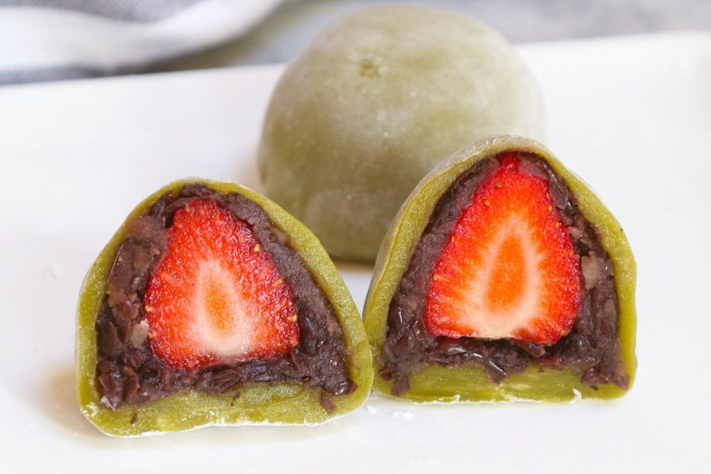 Green tea mochi stuffed with anko red bean paste and strawberries.