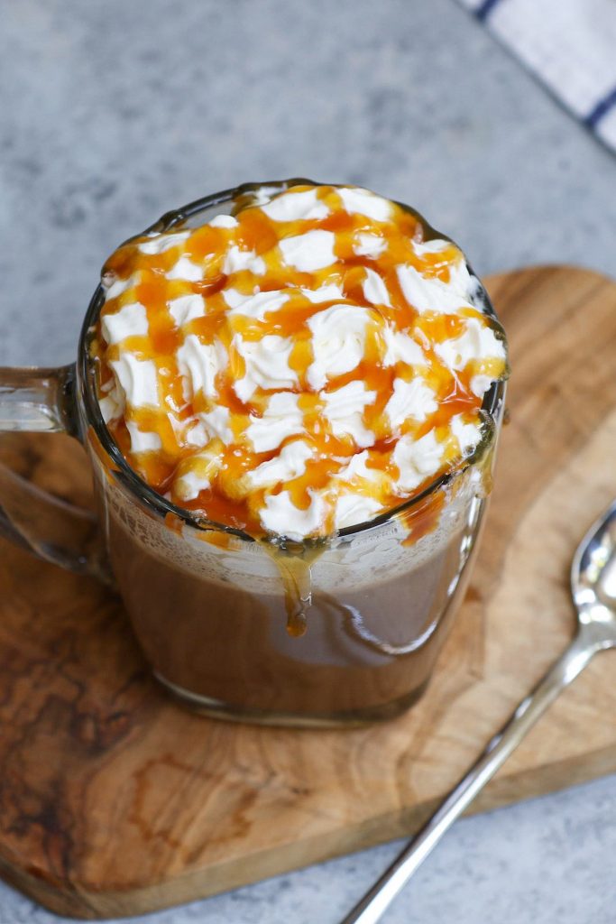 This Salted Caramel Mocha is the real deal! It gives you all the delicious flavor of Starbucks’ drink at the fraction of the price. Sweet, creamy, and full of chocolate and coffee flavor, this homemade salted caramel mocha latte is so easy to make with a few simple ingredients. #SaltedCaramelMocha #StarbucksSaltedCaramelMocha