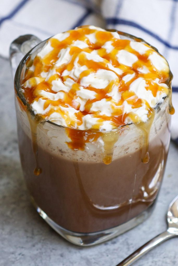 This Salted Caramel Mocha is the real deal! It gives you all the delicious flavor of Starbucks’ drink at the fraction of the price. Sweet, creamy, and full of chocolate and coffee flavor, this homemade salted caramel mocha latte is so easy to make with a few simple ingredients. #SaltedCaramelMocha #StarbucksSaltedCaramelMocha