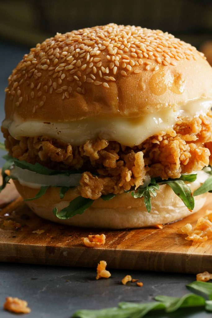 KFC Zinger Burger or Chicken Burger is the perfect fried chicken sandwich with an added “Zing!” for lovers of a little extra heat. Crispy chicken thighs are balanced by a creamy burger sauce, placed on a toasted brioche bun. This copycat recipe is going to be your most requested meal.