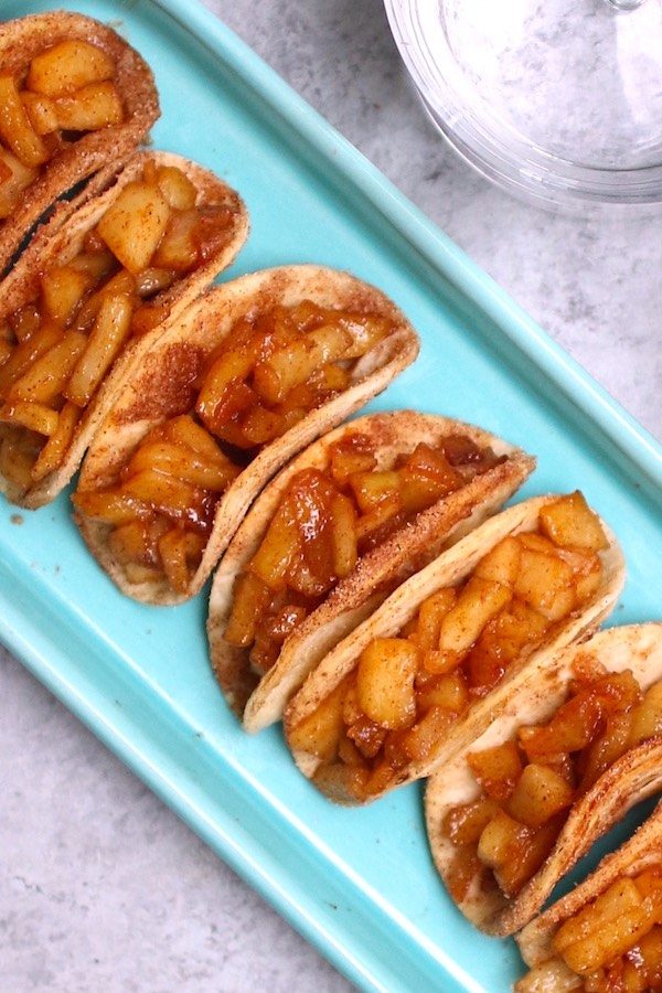 Super Easy Fried Apples with Homemade Tacos – delicious cinnamon sugary fried apples in a crispy and sweet taco, drizzled with caramel sauce, and then topped with whipped cream! The easiest dessert that comes together in no time. All you need is a few simple ingredients: Flour Tortillas, butter, cinnamon, sugar, apples, lemon, caramel sauce and whipped cream. It’s the perfect way to serve apple pie to a crowd!