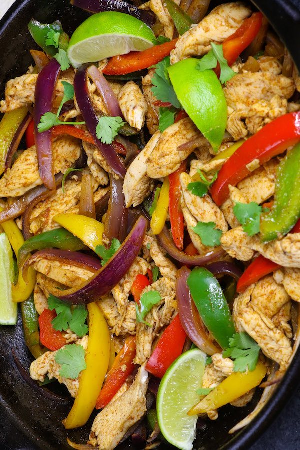 Slow Cooker Chicken Fajitas – Tender and juicy chicken breasts are cooked in the crock pot with bell peppers and onions with flavorful fajita seasonings. It takes 10 minutes to prepare in the morning and you will come home with dinner ready!#ChickenFajitas #SlowCookerChicken