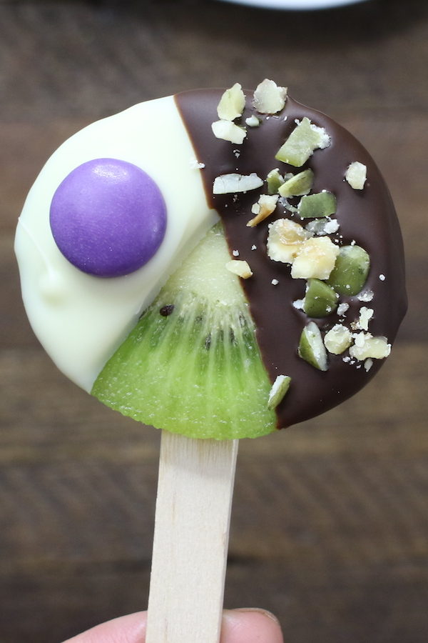 These Chocolate Dipped Kiwi Pops are beautiful and irresistibly delicious, with yummy chocolate and fresh kiwi fruit in every single bite. They melt in your mouth and are perfect for outdoor parties