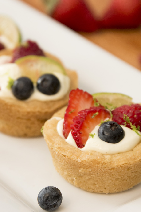 These Key Lime Pie Cookie Cups - smooth and delicious key lime pie cheesecake filling nestling in soft and chewy sugar cookie cups.  So Good!