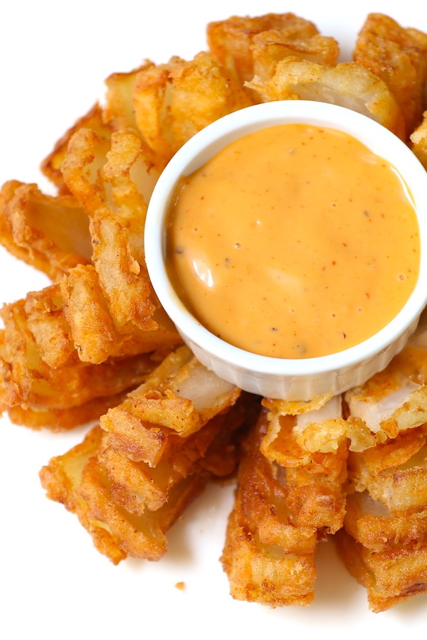 Homemade crispy blooming onion is so easy to make with a few simple techniques. This recipe can rival your favorite outback bloomin onion. 