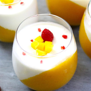 Two-tone mango panna cotta served in wine glasses