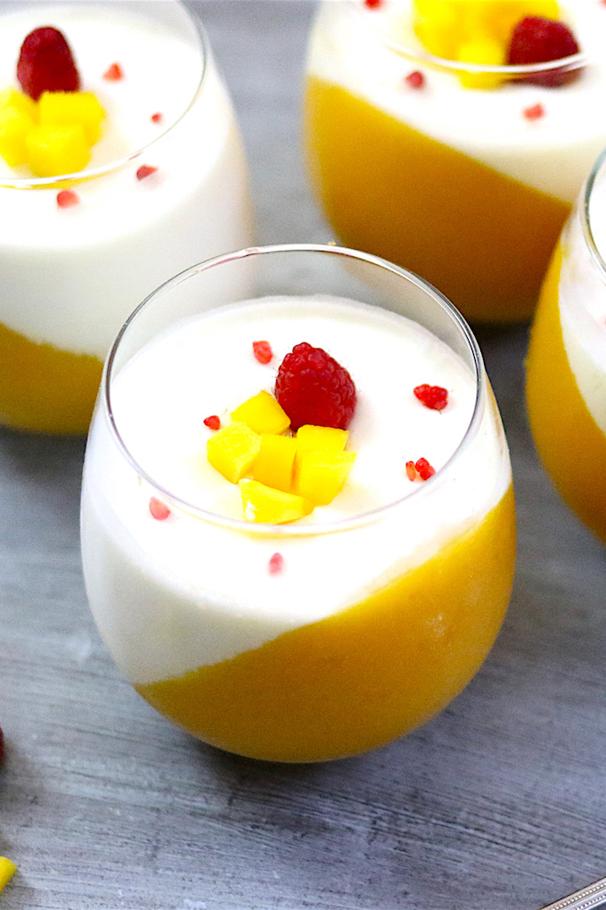 Two-tone mango panna cotta served in wine glasses