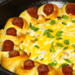 This hot dog chili casserole takes minimal effort to put together. It’s made with biscuit dough stuffed with hot dog, then baked to perfection in a chili sauce topped with cheese.