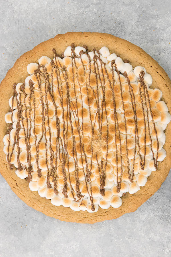 S’mores Pie is gooey, chocolatey, rich and crunchy! Graham cracker crust, toasted marshmallow and rich chocolate are baked into a delicious smores pie. It’s so much better than standing around a campfire