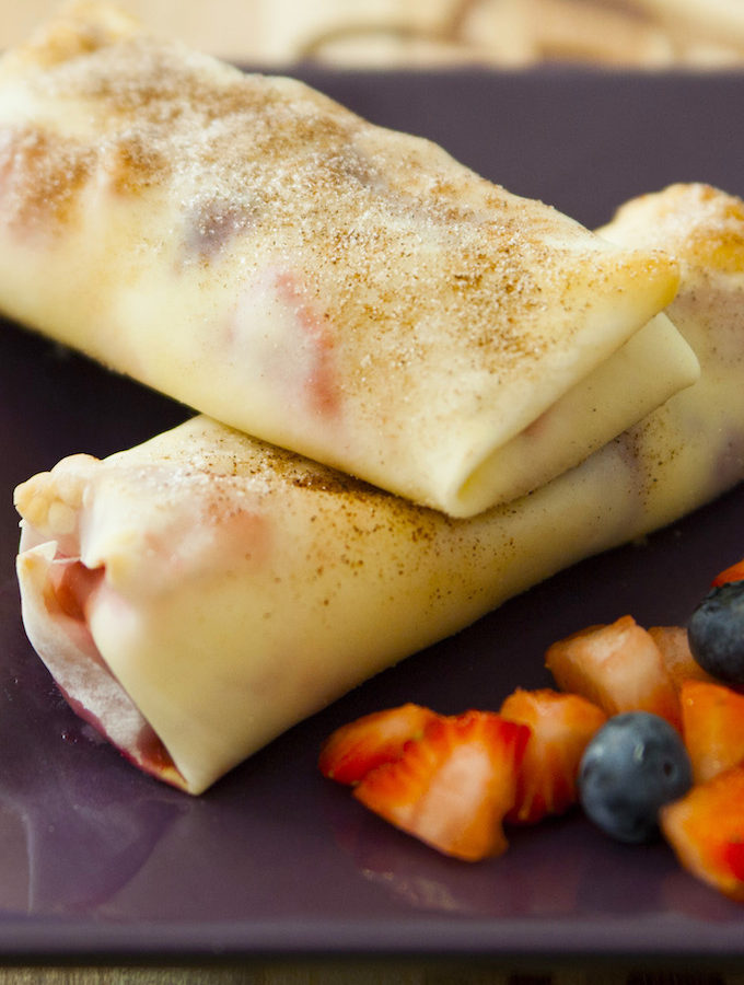 Cheesecake Egg Rolls are filled with cream cheese and mixed berries, all wrapped in soft egg rolls and baked to crispy perfection. The perfect make-ahead appetizer or dessert for any event!