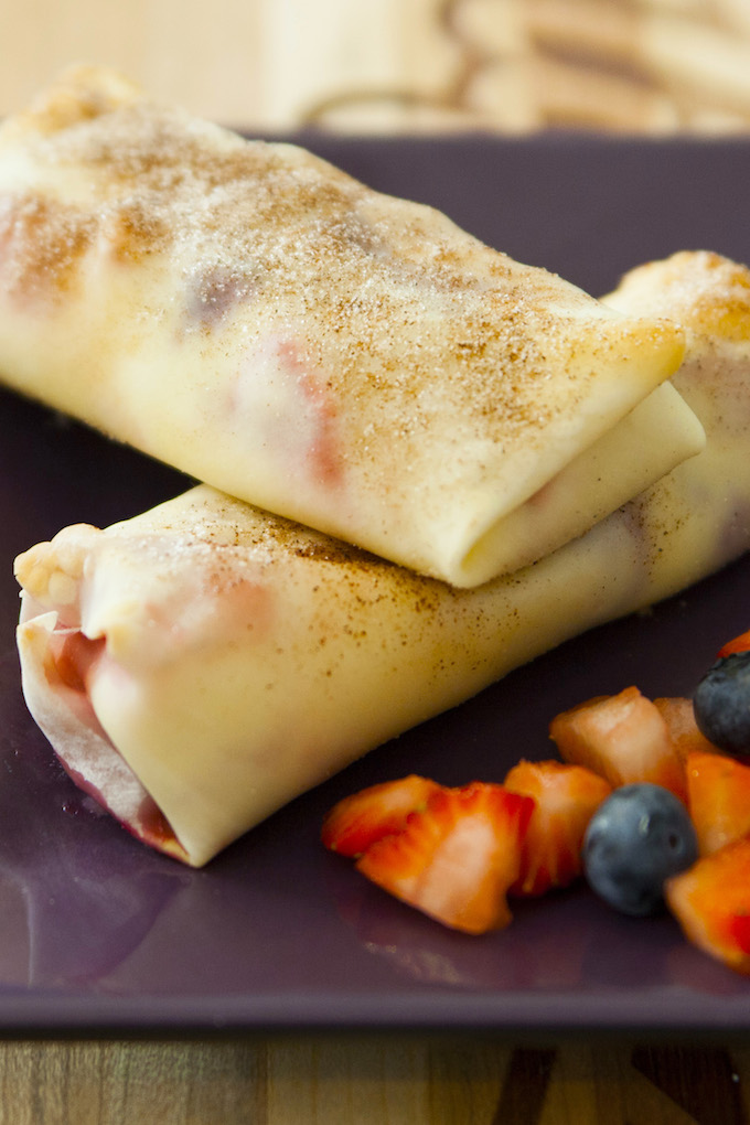Cheesecake Egg Rolls are filled with cream cheese and mixed berries, all wrapped in soft egg rolls and baked to crispy perfection. The perfect make-ahead appetizer or dessert for any event!