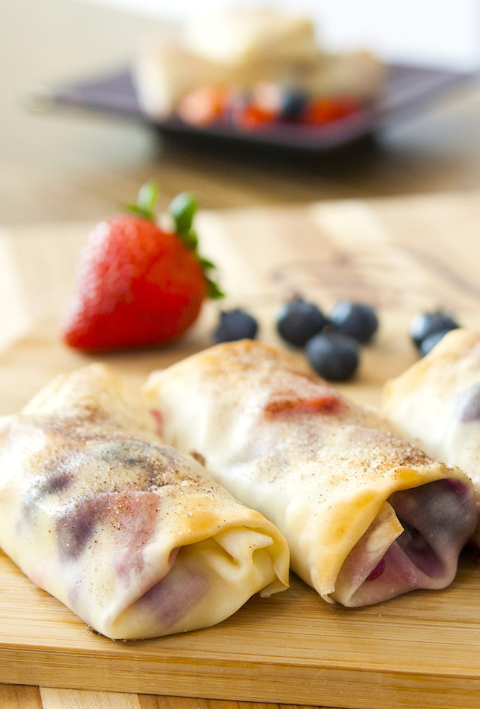 Cheesecake Egg Rolls are filled with cream cheese and mixed berries, all wrapped in soft egg rolls and baked to crispy perfection