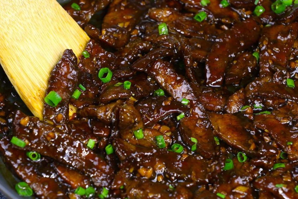 Stir fry beef slices in a skillet