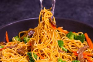 Beef stir fry with noodles, broccoli and carrots