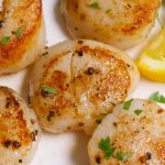 Sous Vide Scallops with lemon and butter sauce are juicy on the inside and crispy on the outside. Cooking in the sous vide cooker first, and then quickly searing at the end for the perfect tender-crisp scallops every time!