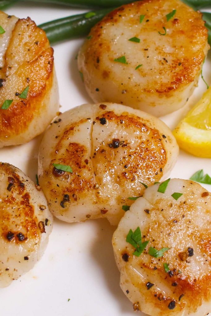Sous Vide Scallops with lemon and butter sauce are juicy on the inside and crispy on the outside. Cooking in the sous vide cooker first, and then quickly searing at the end for the perfect tender-crisp scallops every time! 