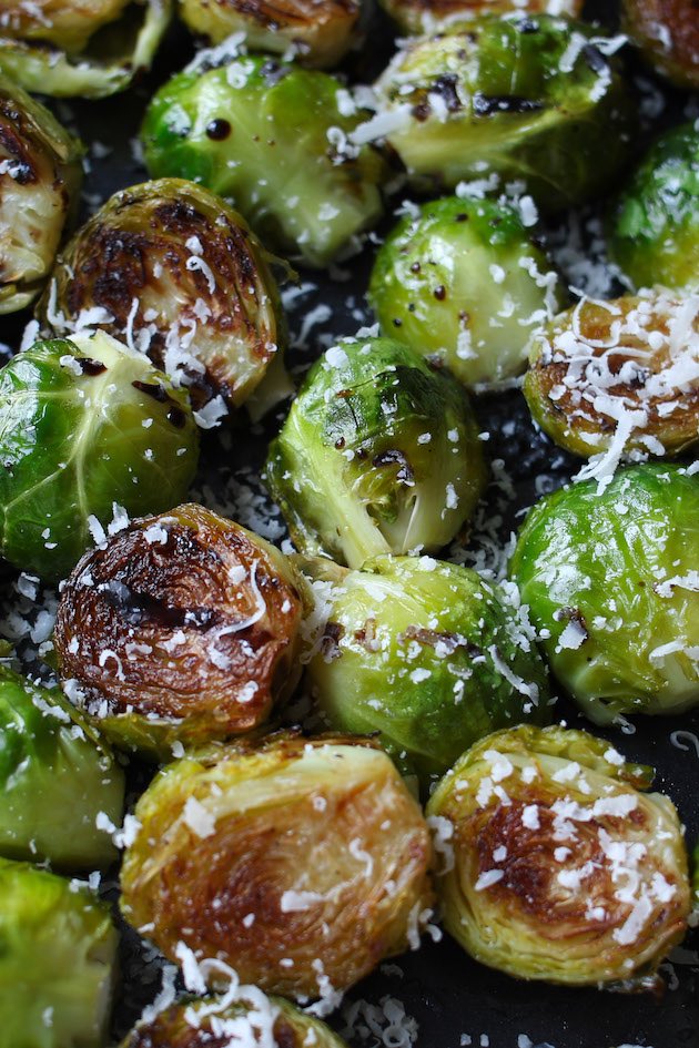 Sous Vide Brussels Sprouts drizzled with balsamic vinegar and sprinkled with parmesan cheese.