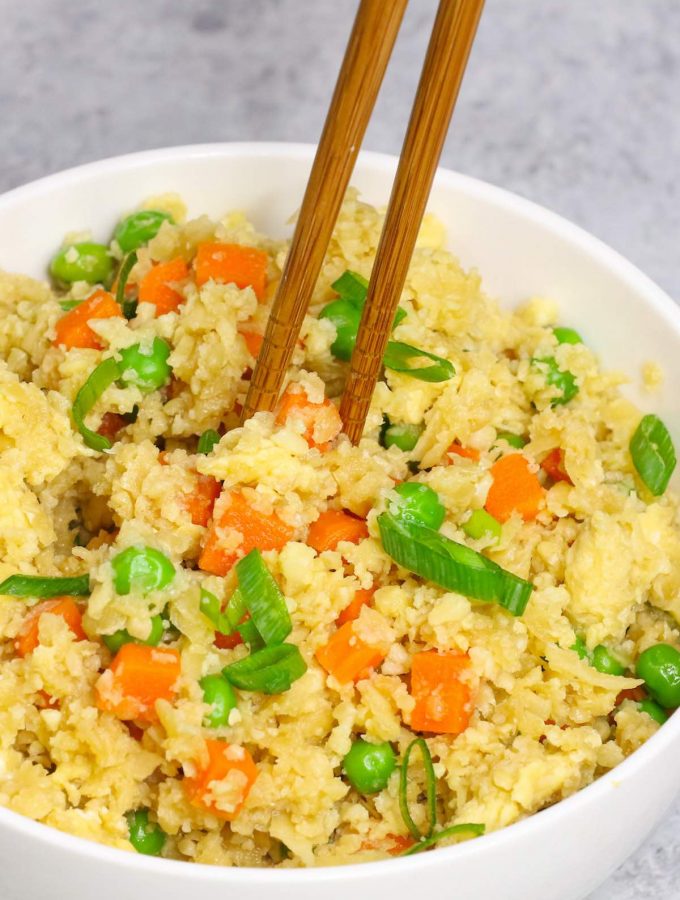 This Easy Microwave Cauliflower Rice recipe makes light and fluffy cauliflower rice in just a few minutes. An amazingly healthy and low carb twist on takeout fried rice. It’s a perfect grain-free and quick side dish! #MicrowaveCauliflowerRice