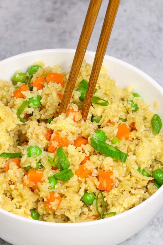 This Easy Microwave Cauliflower Rice recipe makes light and fluffy cauliflower rice in just a few minutes. An amazingly healthy and low carb twist on takeout fried rice. It’s a perfect grain-free and quick side dish! #MicrowaveCauliflowerRice