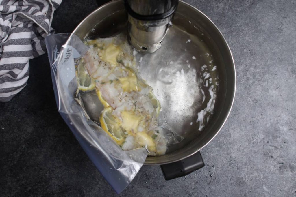 Sous vide cooking halibut in a water bath.