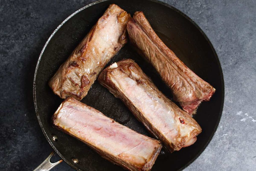 Searing short ribs before sous vide cooking.