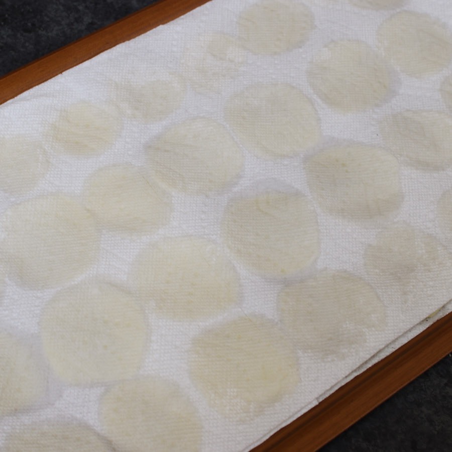 Adding another layer of paper towel on top of the potato slices to soak up the moisture.