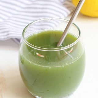A glass of celery juice on the table.