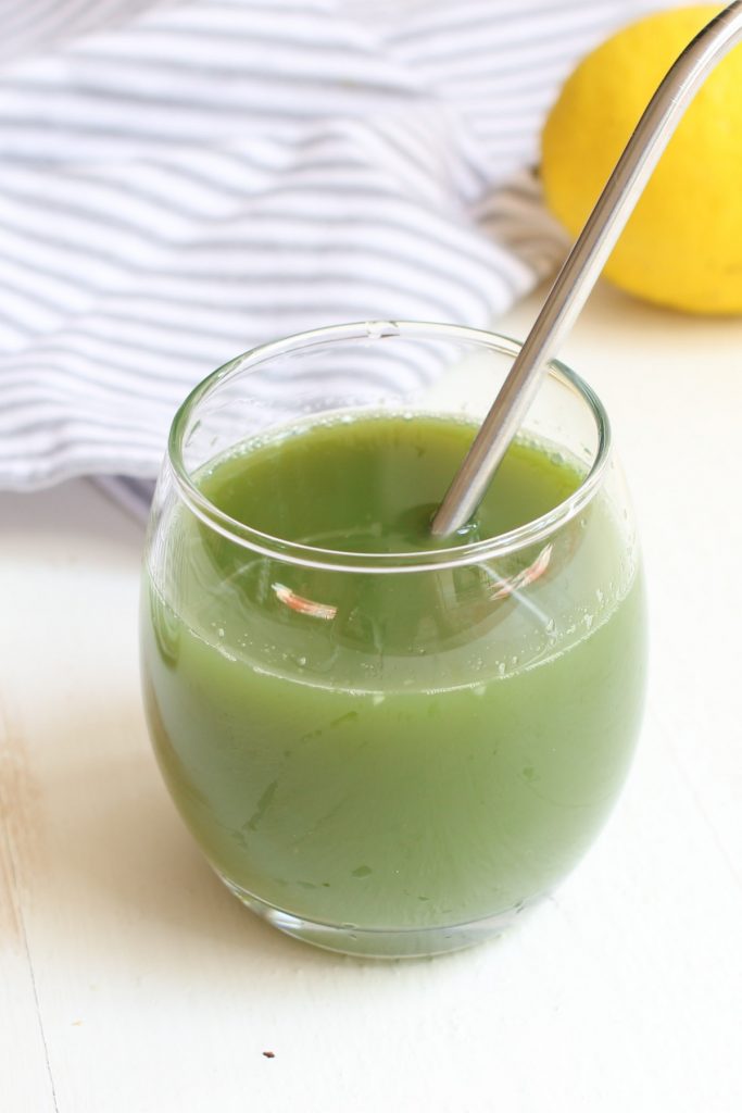 A glass of celery juice on the table.