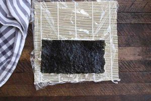 Flip the rice covered nori sheet so that rice is facing down.