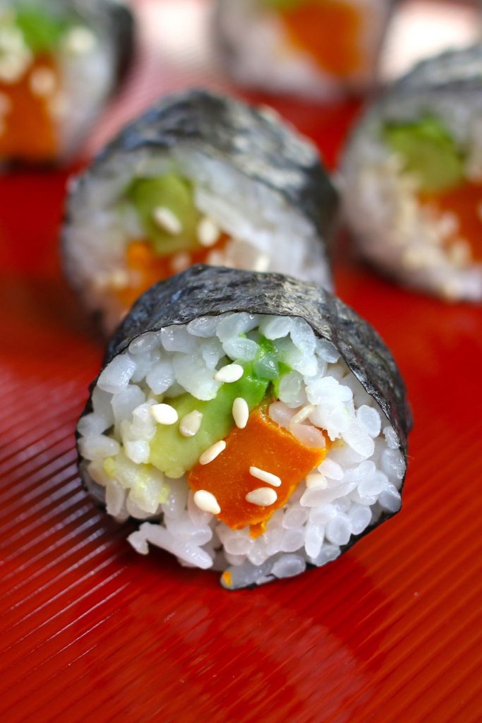 Sweet Potato Sushi Rolls are filled with baked sweet potatoes and creamy avocado, then rolled in nori seaweed sheet! It’s a kid-friendly vegan recipe that’s easy to make at home. I’ll share with you my secret to making the best sweet potato sushi rolls, with step by step photos! #SweetPotatoSushiRoll #SweetPotatoRoll #VegetableRoll