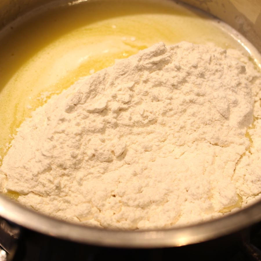 Adding flour to the mixture once butter is melted.