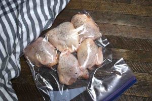 Vacuum-sealed chicken thighs in a zip-loc bag.