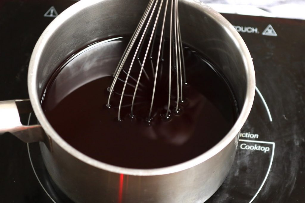 Stirring the mixture with a whisk.