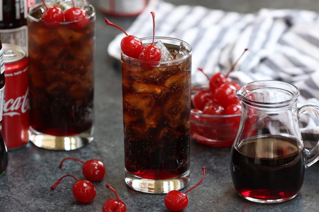 Roy Rogers Drink is refreshing, fizzy and irresistible – one of my go-to mocktails since childhood. The base of this non-alcoholic drink is cola and grenadine syrup, and topped with maraschino cherry. This drink is known for its simplicity and great taste, making the perfect holiday beverage for kids as well as grown-ups! #RoyRogersDrink #RoyRogersRecip e#EasyMocktail