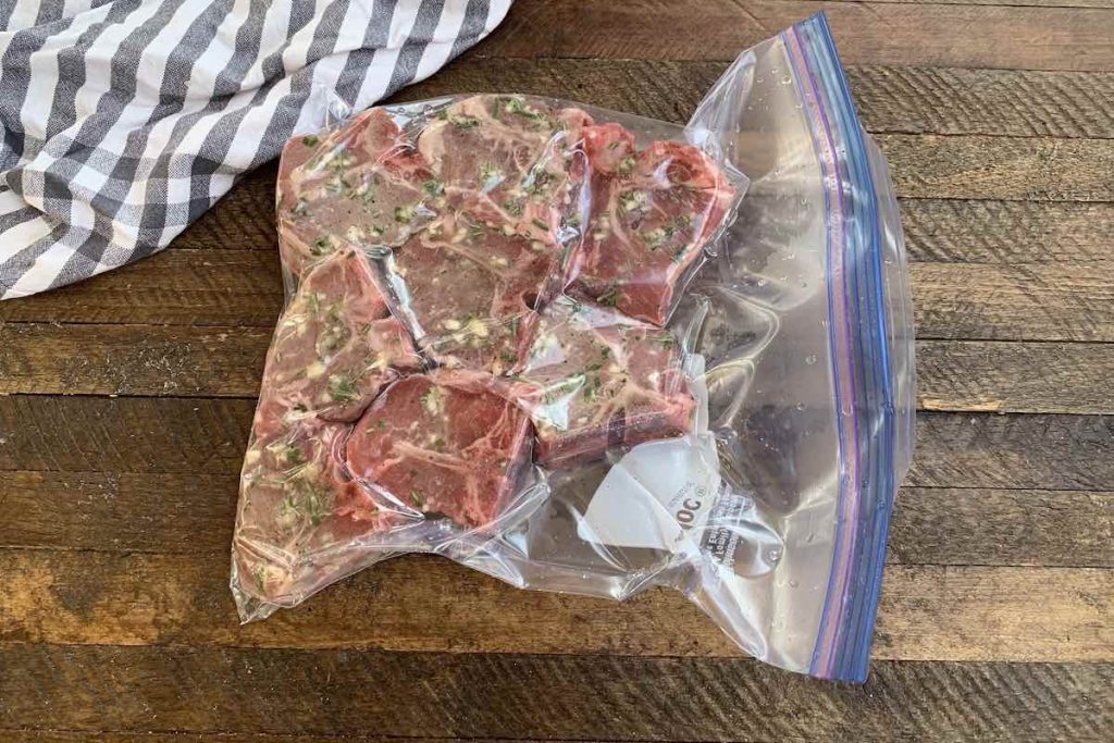 Vacuum-sealed lamb chops in a zip-loc bag.