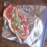 Vacuum-sealed steak using water displacement method.