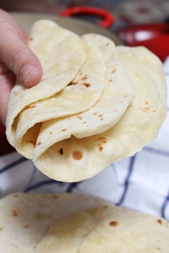 These Homemade Vegan Flour Tortillas are so soft and fluffy – a delicious and healthy alternative to traditional Mexican tortillas. This recipe is easy to make with only 5 inexpensive, easy-to-get ingredients, and can be done completely by hand!