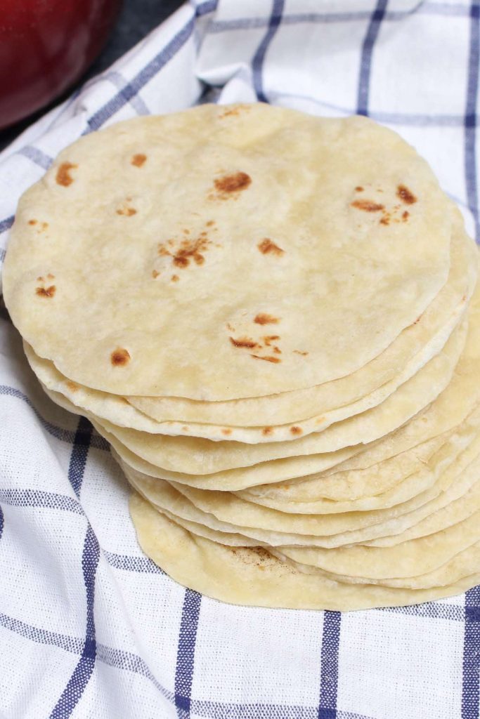 These Homemade Vegan Flour Tortillas are so soft and fluffy – a delicious and healthy alternative to traditional Mexican tortillas. This recipe is easy to make with only 5 inexpensive, easy-to-get ingredients, and can be done completely by hand!