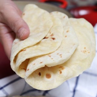 These Homemade Vegan Flour Tortillas are so soft and fluffy – a delicious and healthy alternative to traditional Mexican tortillas. This recipe is easy to make with only 5 inexpensive, easy-to-get ingredients, and can be done completely by hand!