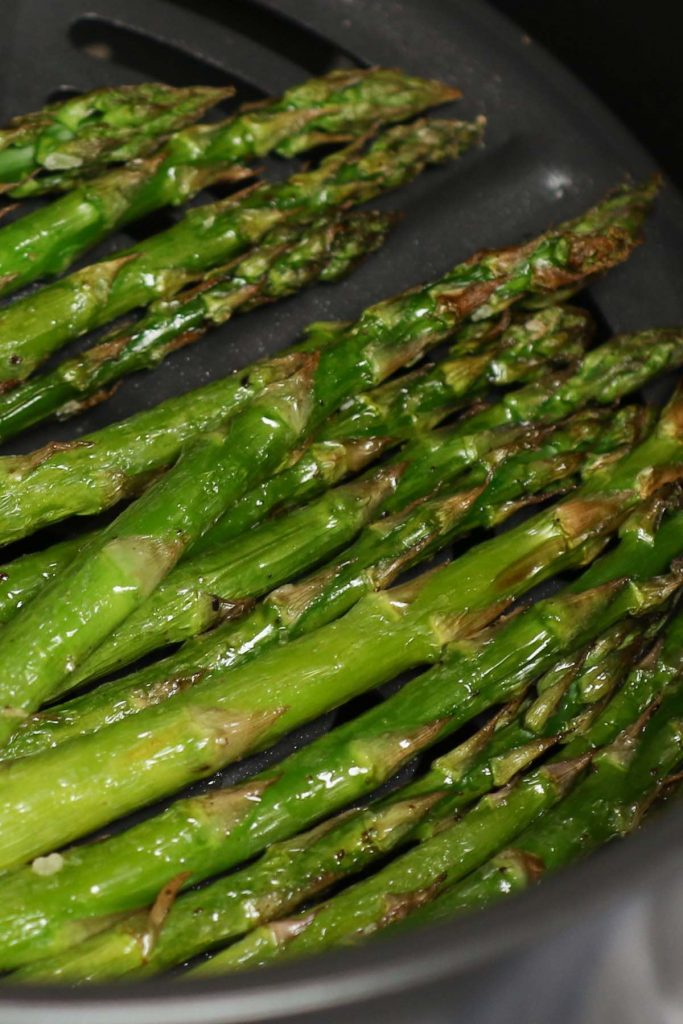 This Air Fryer Asparagus has crispy tips and tender stalks. It takes half of the time to cook with only 4 simple ingredients – the best roasted asparagus for a spring side dish! #AirFryerAsparagus #AirFryerVegetables