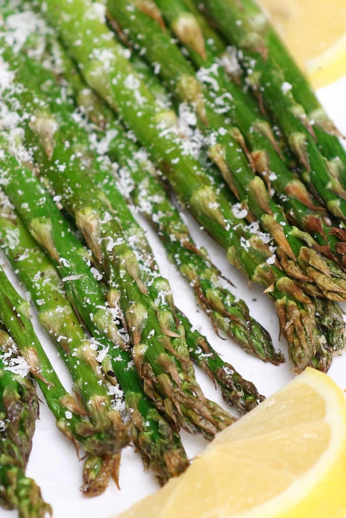 This Air Fryer Asparagus has crispy tips and tender stalks. It takes half of the time to cook with only 4 simple ingredients – the best roasted asparagus for a spring side dish! #AirFryerAsparagus #AirFryerVegetables