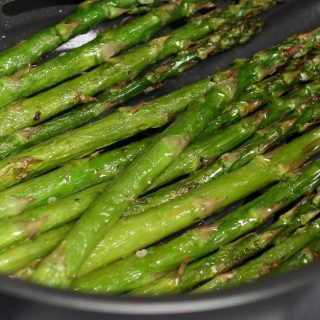 This Air Fryer Asparagus has crispy tips and tender stalks. It takes half of the time to cook with only 4 simple ingredients – the best roasted asparagus for a spring side dish! #AirFryerAsparagus #AirFryerVegetables