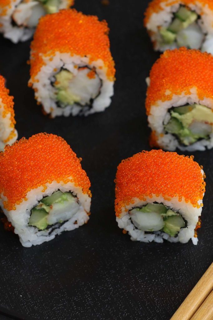 Boston Rolls are filled with creamy avocado, succulent shrimp, and crunchy cucumber, then rolled in nori seaweed sheet and sushi rice! It’s usually garnished with the bright orange tobiko (Japanese flying fish roe). In this recipe, you will learn how to make sushi rice, how to select fillings, how to roll the the sushi, and how to garnish with tobiko! #BostonRoll #BostonSushi #BostonRollSushi