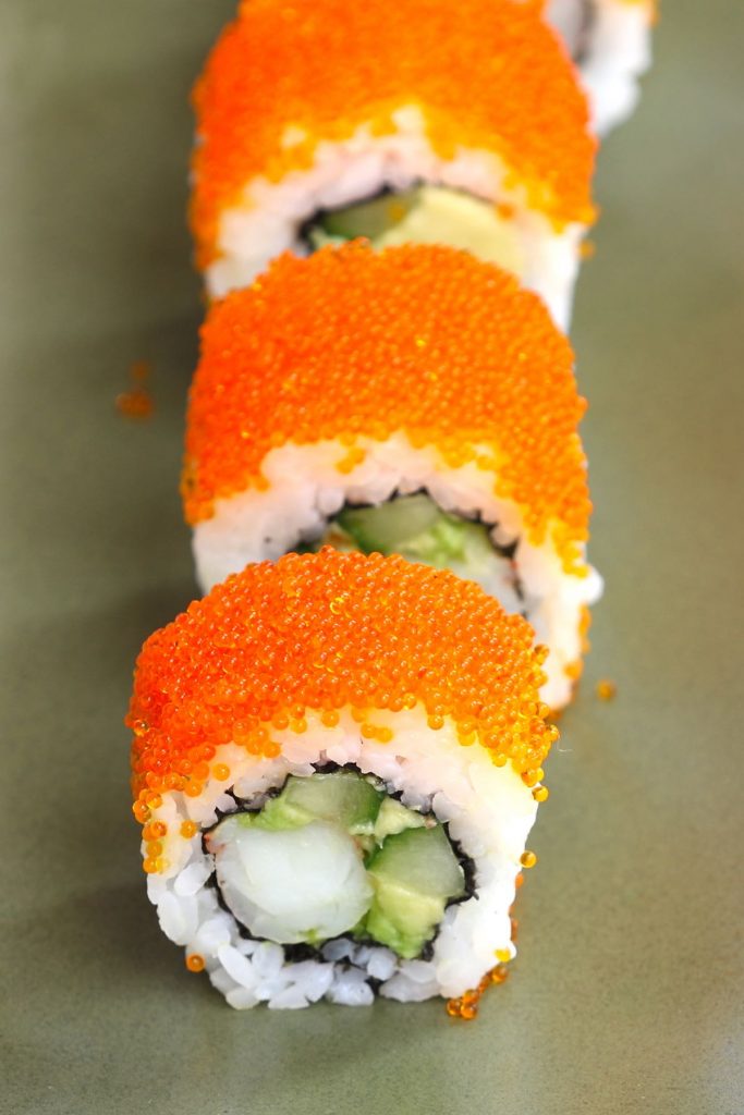 Boston Rolls are filled with creamy avocado, succulent shrimp, and crunchy cucumber, then rolled in nori seaweed sheet and sushi rice! It’s usually garnished with the bright orange tobiko (Japanese flying fish roe). In this recipe, you will learn how to make sushi rice, how to select fillings, how to roll the the sushi, and how to garnish with tobiko! #BostonRoll #BostonSushi #BostonRollSushi